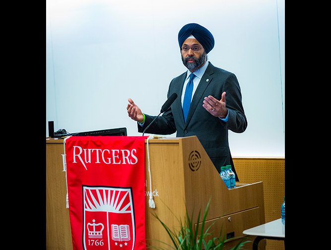 Attorney General Gurbir Grewal speaking at the podium